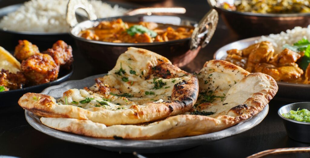 naan bread with herbs and garlic seasoning on plate